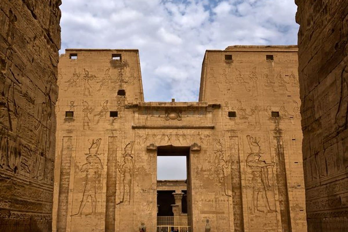 A near-empty temple courtyard in Upper Egypt during the quiet July travel season